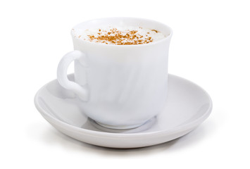 Coffee with foamed cream and cinnamon powder in cup closeup