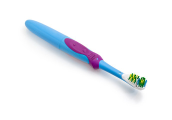 Standard electric toothbrush on a white matte surface