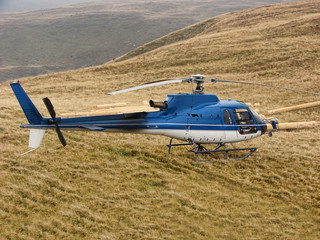 Blue helicopter on the mountain