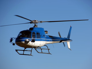 Blue helicopter on  blue sky 