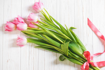 Pink tulip flower on wooden background