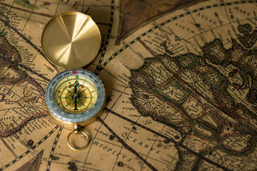 Obraz na płótnie Canvas Old compass on vintage map