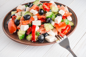Vegetable salad on a wooden white table