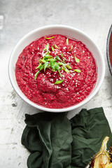 Overhead image of traditional jewish and middle eastern food spicy beetroot dip on metallic background. Israeli cuisine concept