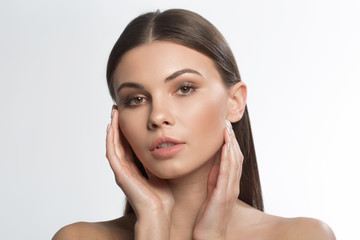 Portrait of sensual young woman touching his soft facial skin with pleasure. Healthy beauty...