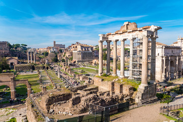 Fototapeta na wymiar The ruins of the Roman Forum in Rome, Italy with the Colosseum visible in the back