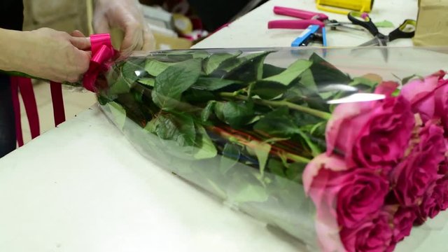 florist tie ribbon on a bouquet of pink roses