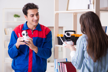 Client getting securty camera installed at home by contractor