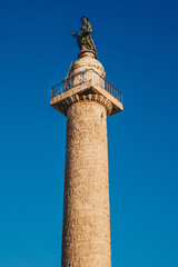 Fototapeta na wymiar Trajan's Column (Colonna Traiana) in Rome, Italy. Commemorates Roman emperor Trajan's victory in the Dacian Wars