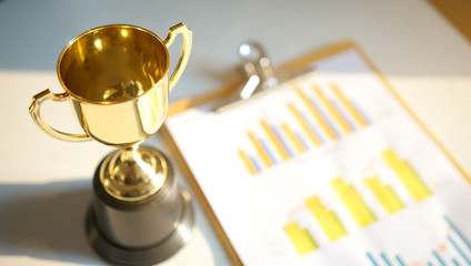 financial diagram with golden trophy on background. business successful concept