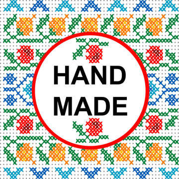 Handmade round frame over a colored cross stitch pattern