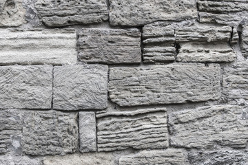 Ancient crumbling stones are located in the old fortress wall. Baku. Azerbaijan.