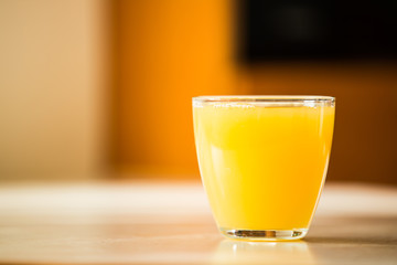 Fresh ananas juice in a glass, standing on table.