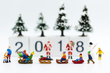 Miniature people: Children playing on snow funny together. Image use for Christmas festival