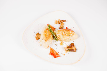 Traditional polish dish called kartacz - potato dumplings stuffed with meat and served with crispy bacon, caramelized onion and fried boletus
