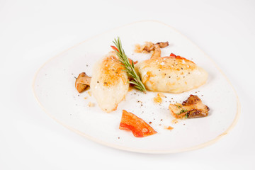 Traditional polish dish called kartacz - potato dumplings stuffed with meat and served with crispy bacon, caramelized onion and fried boletus