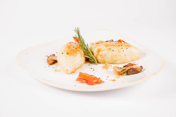 Traditional polish dish called kartacz - potato dumplings stuffed with meat and served with crispy bacon, caramelized onion and fried boletus