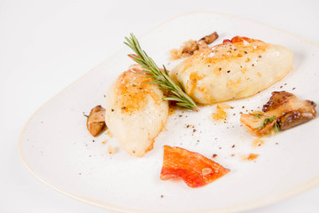 Traditional polish dish called kartacz - potato dumplings stuffed with meat and served with crispy bacon, caramelized onion and fried boletus