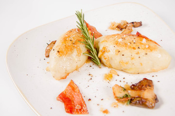 Traditional polish dish called kartacz - potato dumplings stuffed with meat and served with crispy bacon, caramelized onion and fried boletus