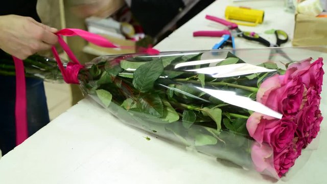 florist tie ribbon on a bouquet of pink roses