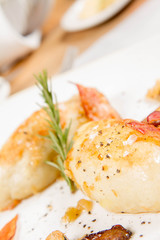 Traditional polish dish called kartacz - potato dumplings stuffed with meat and served with crispy bacon, caramelized onion and fried boletus