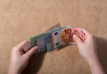 Hand holding American dollar  isolated on wooden background