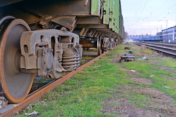 Close-ups Steel diesel railcar train bogie wheels on the tracks.