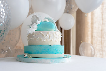Blue birthday cake for baby. First kid birthday decorations with cake and balloons.