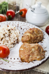 Delicious cutlets, rice, tomatoes and parsley