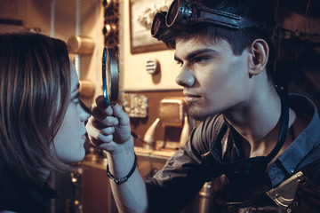 Portrait of a young beautiful loving couple in steampunk style.