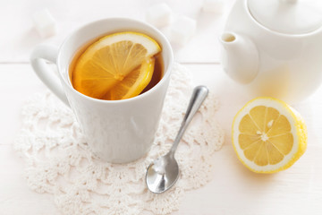 Cup of lemon tea and a teapot