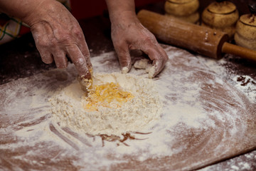Female hands making dough for pizza. Making bread. Cooking Process Concept