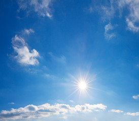 blue sky with white clouds and sun