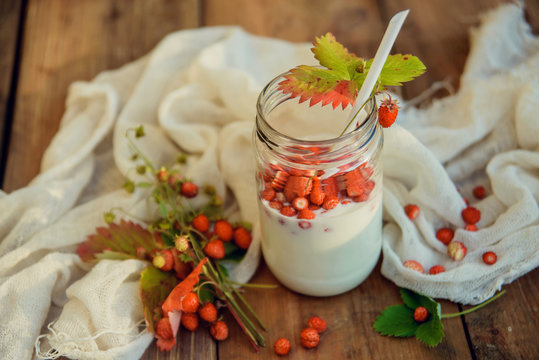 Strawberry milkshake in mason jars on white