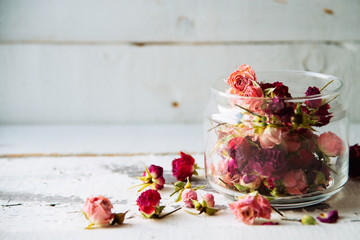Rose buds tea, tea strainer and glass jar. Selective focus.