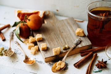 mulled wine in a mug and ingredients for making a drink on a white wooden background, top view
