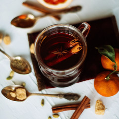 Cup of herbal tea on dark aged rustic background, top view, place for text, border