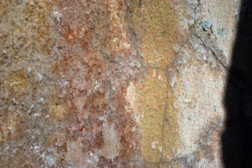 Old very rusty metal background texture with dark shadow on one side, color palette from bright orange to dark brown