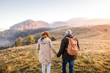 Senior couple on a walk in an autumn nature.