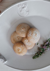 A beautiful cookie on a platter. Flowers in the background