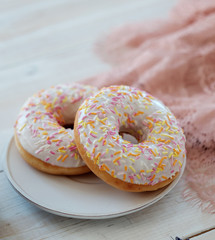 Donuts with icing on pastel background. 