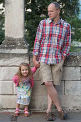 Father with his daughter individually full length street down town portrait