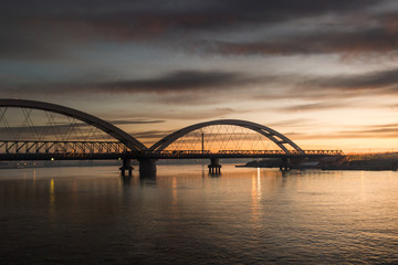 Panorama photo view at sunrise of the city bridge and the river