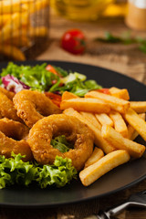 Roasted squid rings with fries.