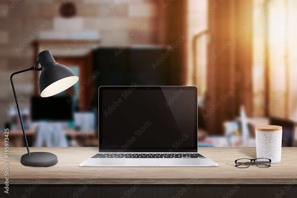 Canvas Prints laptop computer on table in office with brick walls. window and sunlight in background.