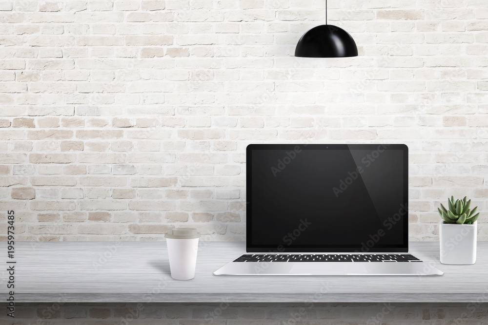 Poster laptop on office desk with free space on left side for text, picture frame or product presentation.