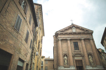 Church of Saint Christopher with statues on facade in Siena