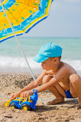 child playing on the beach with sand