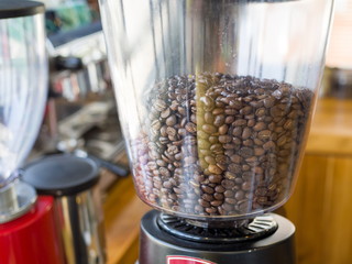 Coffee grinder - coffee beans in the electric coffee grinder