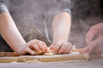 Making dough by female hands at home in kitchen